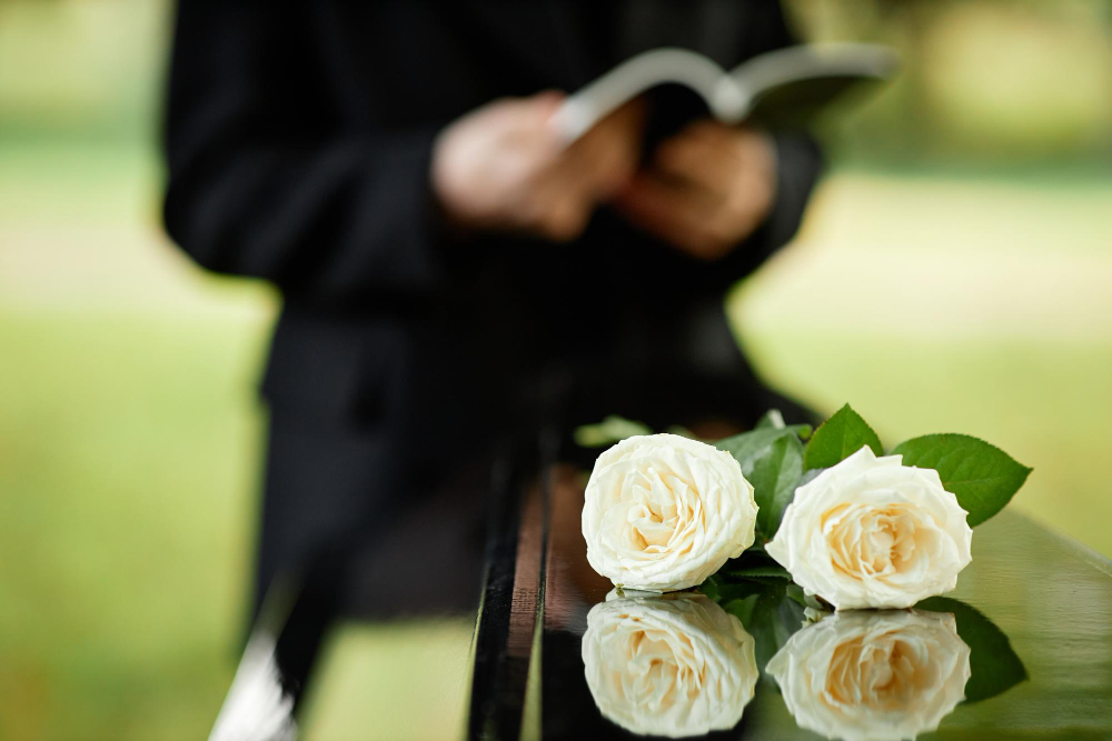 closeup two white roses coffin outdoor funeral ceremony copy space
